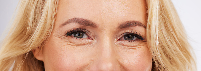 Image showing Skincare, eyes and zoom, mature woman in anti ageing treatment portrait isolated on grey background in studio. Health, skin and beauty, happy model face, eye closeup in luxury spa collagen facial.