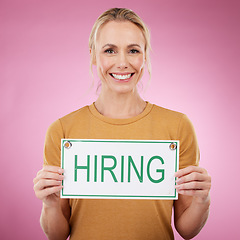 Image showing Woman, hiring sign and studio portrait, announcement or human resources on pink background. Happy female model advertising job hire, opportunity and signage for recruitment, work application or offer