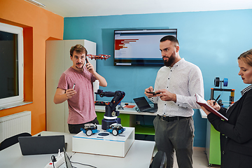 Image showing A group of students working together in a laboratory, dedicated to exploring the aerodynamic capabilities of a drone