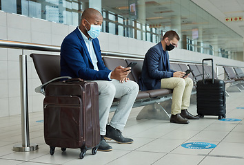 Image showing Social distance, suitcase and businessmen waiting in the airport and networking with cellphone. Face mask, luggage and professional male employees sitting with travel restrictions browsing on a phone