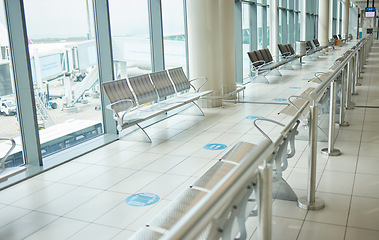 Image showing Airport, lounge chairs and terminal waiting room for global travel, covid regulations or immigration journey. Empty airplane lobby, seat or space of commercial flight, building interior or background