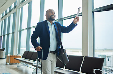 Image showing Black man, ticket and airport walking to departure for travel, business trip or journey by windows. Happy African American male with smile holding document or boarding pass ready for airplane flight