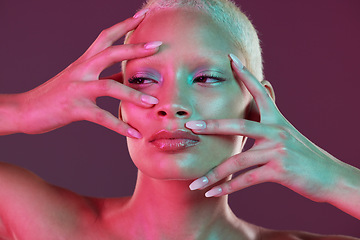 Image showing Neon makeup, woman with hands in face, skincare and lights for creative advertising on studio background. Cyberpunk, fantasy girl and art model isolated for skin care and futuristic mock up space.