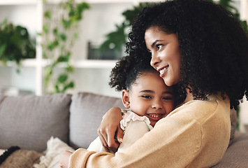 Image showing Hug, love and black family by girl and mother on a sofa, happy and relax in their home together. Mom, daughter and embrace on a couch, cheerful and content while sharing a sweet moment of bonding
