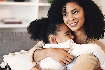 Image showing Love, black family and hug by girl and mother on a sofa, happy and relax in their home together. Mom, daughter and embrace on a couch, cheerful and content while sharing a sweet moment of bonding