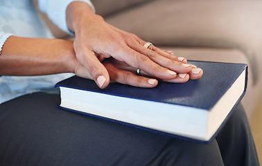 Image showing Bible, prayer and hands of old woman in living room for religion, book and Christian faith. Spiritual, God and worship with senior lady praying with holy text at home for wellness, believe and goal