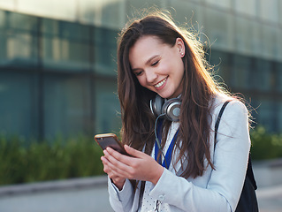 Image showing Business woman, phone and smile for communication, social media or texting and chatting in city. Happy female typing and smiling on smartphone for 5G connection, mobile app or browsing in networking