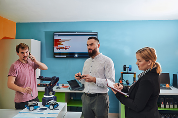 Image showing A group of students working together in a laboratory, dedicated to exploring the aerodynamic capabilities of a drone