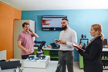 Image showing A group of students working together in a laboratory, dedicated to exploring the aerodynamic capabilities of a drone