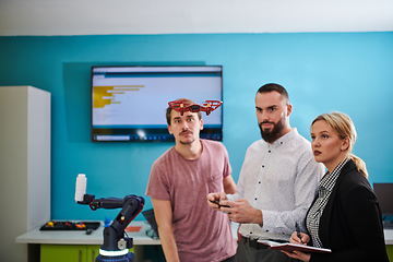 Image showing A group of students working together in a laboratory, dedicated to exploring the aerodynamic capabilities of a drone