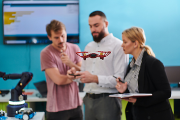 Image showing A group of students working together in a laboratory, dedicated to exploring the aerodynamic capabilities of a drone