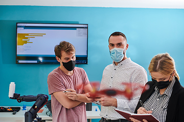 Image showing A group of students working together in a laboratory, dedicated to exploring the aerodynamic capabilities of a drone