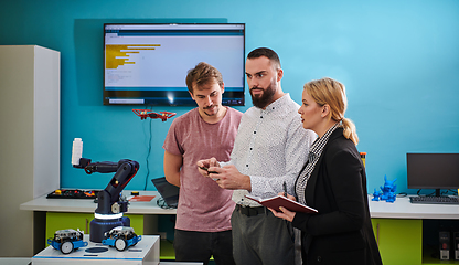 Image showing A group of students working together in a laboratory, dedicated to exploring the aerodynamic capabilities of a drone