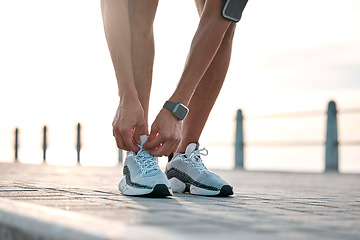 Image showing Fitness, running and man tie shoes by ocean ready for exercise, marathon training and cardio workout. Start sports mockup, athlete and feet of male runner with shoelace for wellness and health