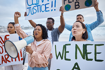 Image showing Protest, climate change and megaphone with woman at the beach for environment, earth day and action. Global warming, community and pollution with activist crowd for social justice, support or freedom