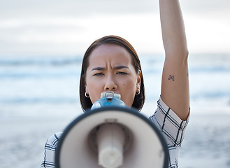 Image showing Megaphone, climate change protest and Asian woman at beach protesting for environment, global warming and to ocean stop pollution. Save the earth, activism and angry female shouting on bullhorn.