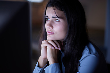 Image showing Thinking, working and woman in office at night reading information on computer while doing research. Overtime, professional and female employee contemplating and planning company report in workplace.