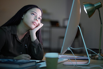 Image showing Tired, bored woman at her computer studying at night with depression, burnout or mental health risk. Sleepy, sad or depressed young person or student with fatigue, low energy and working at desk