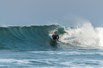 Image showing Bodyboarder surfing ocean wave