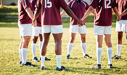 Image showing Man, team and holding hands in fitness for sports motivation, collaboration or coordination and goal on field. Group of men huddle in circle for teamwork, community or sport strategy and solidarity