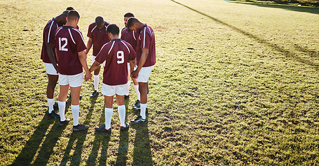 Image showing Men, huddle and team holding hands praying on grass field for sports coordination or collaboration outdoors. Group of sport players in fitness training, planning or getting ready for game on mockup