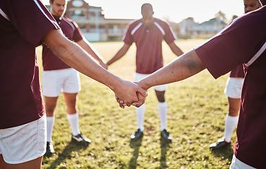 Image showing Man, team and holding hands for sports huddle, collaboration or coordination on grass field. Group of men touching hand in circle for teamwork, community or sport solidarity for outdoor game or match