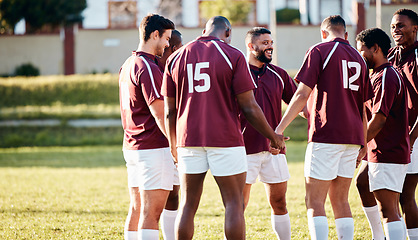 Image showing Man, team and holding hands on grass field for sports motivation, coordination or collaboration outdoors. Group of sport players in huddle for fitness training, goal or strategy together for game