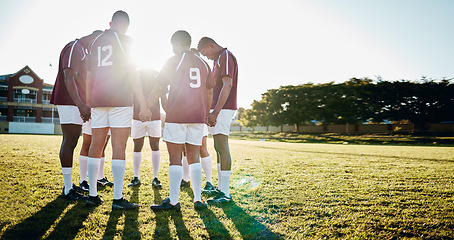 Image showing Man, team and holding hands in sports huddle for fitness, collaboration or goal on grass field. Group of men in circle or scrum for teamwork, community or sport strategy and game solidarity