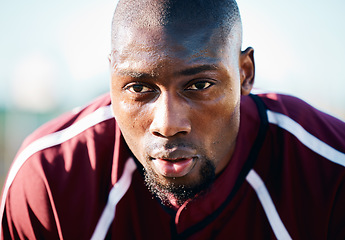 Image showing Breathing, focus and black man in sports training, competition or game on rugby field and blue sky. Breathe, sweating and tired athlete or person thinking of workout, exercise or fitness strategy