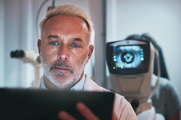 Image showing Optometry, healthcare and optometrist doing a eye test in the clinic for eyecare or vision. Medical, tablet and senior male ophthalmologist doing optic research on a mobile device in a optical store.