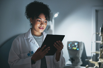 Image showing Medical doctor, tablet and black woman in hospital for online consultation, research or telehealth at night. Healthcare, technology and female physician with touchscreen for wellness app in clinic.