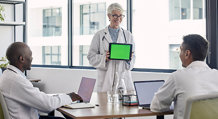 Image showing Green screen, tablet presentation and doctors meeting for hospital research, results and software clinic solution. Medical professional, mockup space and senior woman success with stakeholder people