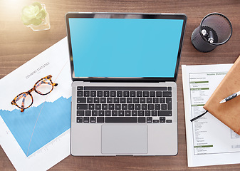 Image showing Mockup, green screen and documents with laptop on desk from above for finance planning, investment and review. Accounting, technology and overhead with device for growth, savings and tax report