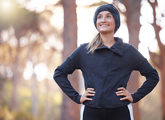 Image showing Happy fitness, woman and thinking on hiking in park, forest and woods for exercise, training and workout. Female hiker smile with happiness, motivation and mindset for wellness goals, freedom or idea