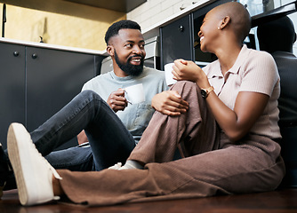 Image showing Relax, talking and an African couple with coffee on the kitchen floor in the morning. Love, happy and black man and woman drinking a cup of tea, latte or warm beverage with conversation together