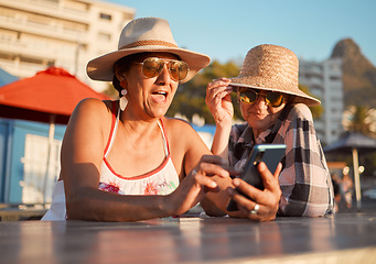 Image showing Friends, senior women and phone for internet, search or browse social media, break or summer, retirement or holiday. Elderly people and ladies bond for profile picture or meme at outdoor restaurant