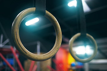 Image showing Gymnastics ring, training and equipment in an empty gym for olympics preparation closeup from below. Exercise, health and interior with sports rings in a fitness center for an olympic workout