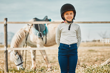 Image showing Happy, ranch and portrait of a girl with a horse on a farm before riding lessons in the countryside. Nature, happiness and child standing by a animal or pet in natural outdoor environment on weekend.