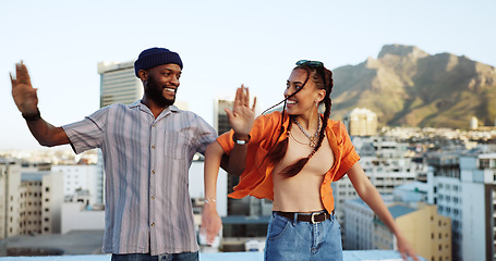 Image showing African friends, dance and love smile laughing fun together on city building rooftop. Black American man, happy trendy woman and couple bonding or friendship spiritual freedom dance in urban town