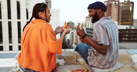 Image showing Couple, eating and pizza date on city building rooftop in New York for bonding, trust or love support. Smile, happy or talking woman and black man with fast food in relax tourist location for summer