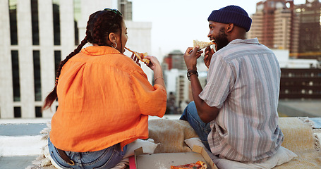 Image showing Couple, eating and pizza date on city building rooftop in New York for bonding, trust or love support. Smile, happy or talking woman and black man with fast food in relax tourist location for summer