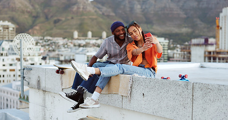 Image showing Selfie, rooftop and couple with skateboard and smartphone for social media post, social network update or gen z lifestyle blog with urban cityscape. Influencer black people friends in phone portrait