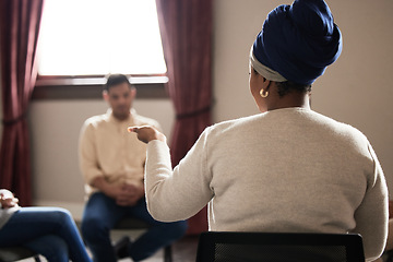 Image showing Support, black woman and group of people in therapy with understanding, sharing feelings and talking in session. Mental health, addiction or depression, men and women with therapist sitting together.