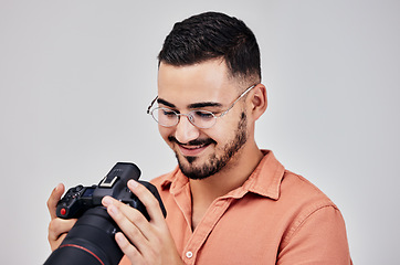 Image showing Photographer, camera and art with a creative man in studio on a gray background for modern photography. Media, production and photoshoot with a male photo professional or artist working backstage