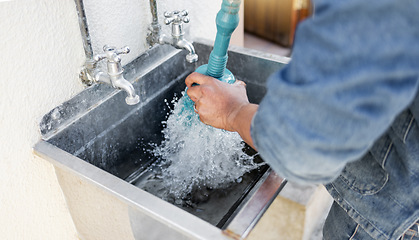 Image showing Plumber, water and man with plunger for kitchen sink, maintenance and repairs, blockage or cleaning. Plumbing, drain and professional handyman fixing, clear and working with equipment for system fix