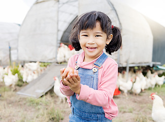 Image showing Portrait, Asian girl and farm for agriculture, chicken and happiness on holiday, vacation and holding eggs. Face, female child or kid in Japan, farming and sustainability with animals and countryside