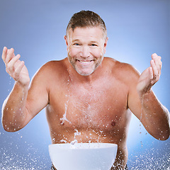 Image showing Skincare, water and man washing face in a studio for a beauty, natural and cosmetic routine. Happy, smile and portrait of a senior male model doing a facial cleansing treatment by a purple background