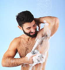 Image showing Skincare, man and foam with water, cleaning and showering for wellness and hygiene against blue studio background. Male, gentleman and washing for morning routine, daily and dermatology on backdrop