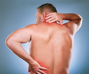 Image showing Back, man and pain with inflammation, injury and body ache with blue studio background. Mature male, gentleman or emergency with neck, bruise or broken with red highlight for muscle tension or strain