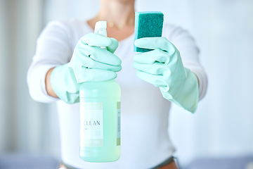 Image showing Woman, hands and detergent for housekeeping, cleaning or disinfect with latex gloves in sanitary home. Hand of female cleaner holding sanitizer bottle and sponge for domestic work or clean hygiene